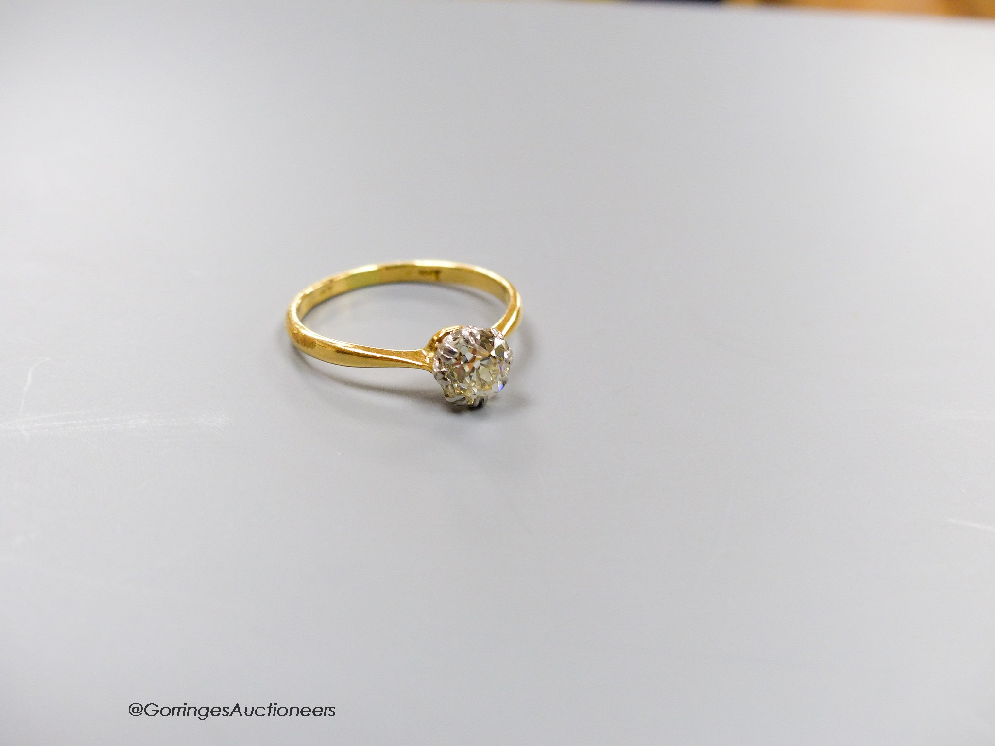 An 18ct and solitaire diamond ring, size O, gross 2.3 grams.